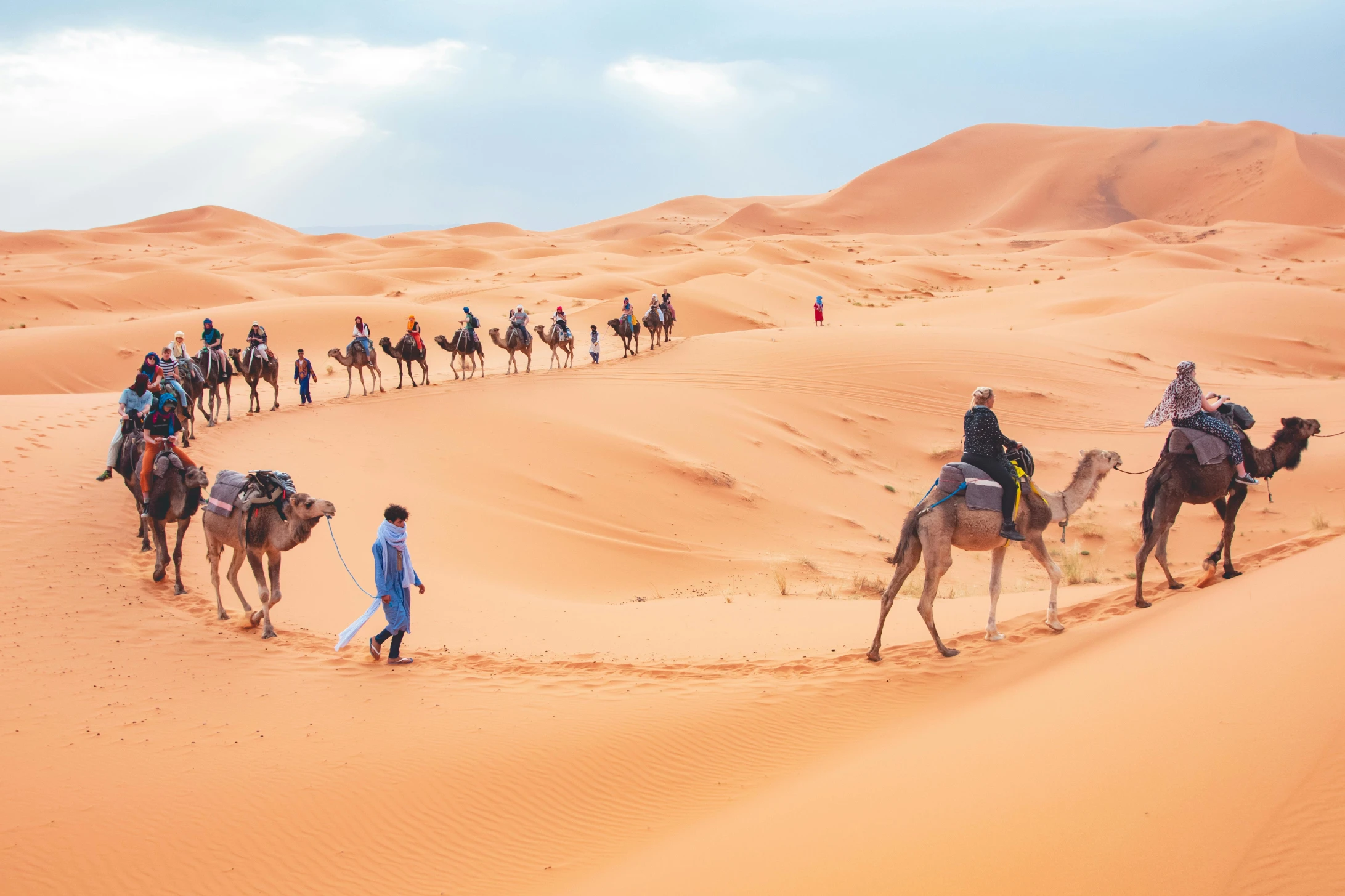 Travelers on camels during 3 days tour from Marrakech to Merzouga desert