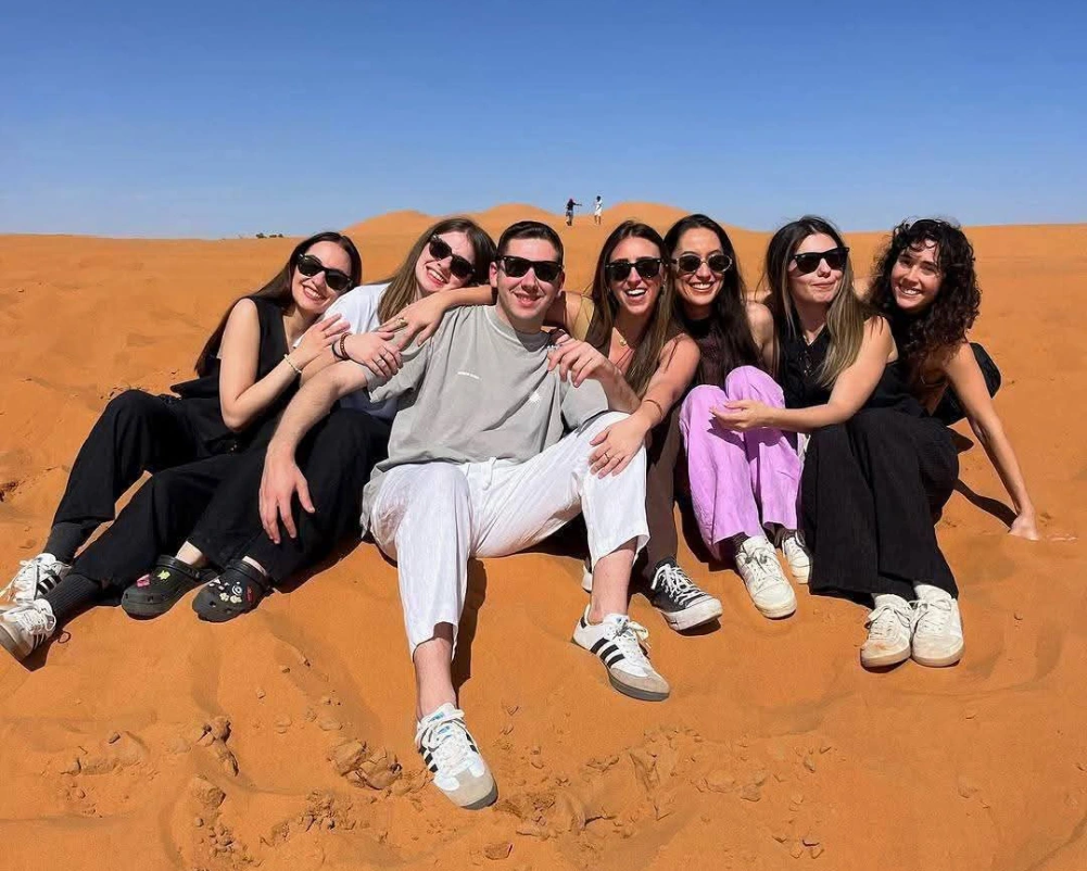 2 Days Tour From Marrakech To Zagora Desert 2 Happy travelers enjoying sunset