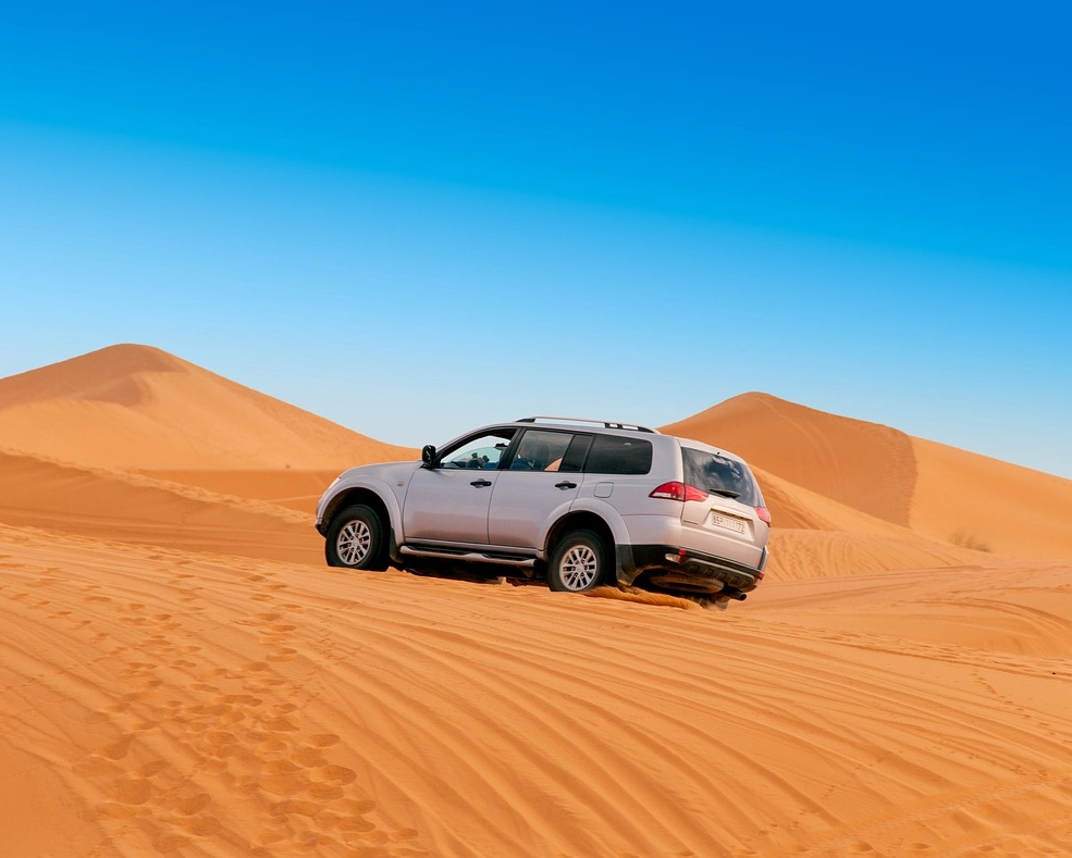 4x4 vehicle driving through diverse Merzouga desert landscape