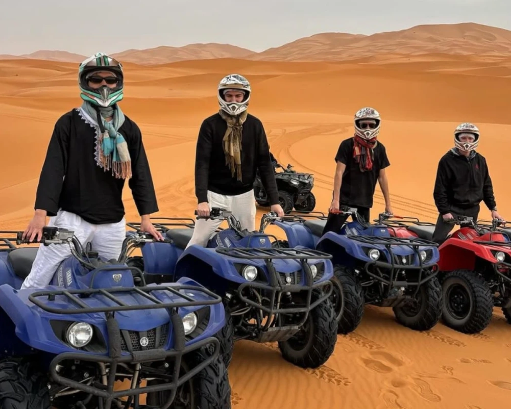 Merzouga Activities 7 Tourist riding ATV quad bike on Merzouga sand dunes