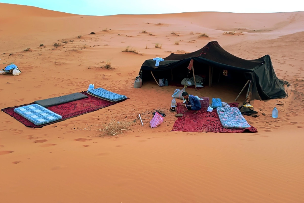 Merzouga Activities 4 Mobile desert camp setup among Merzouga dunes with camels nearby