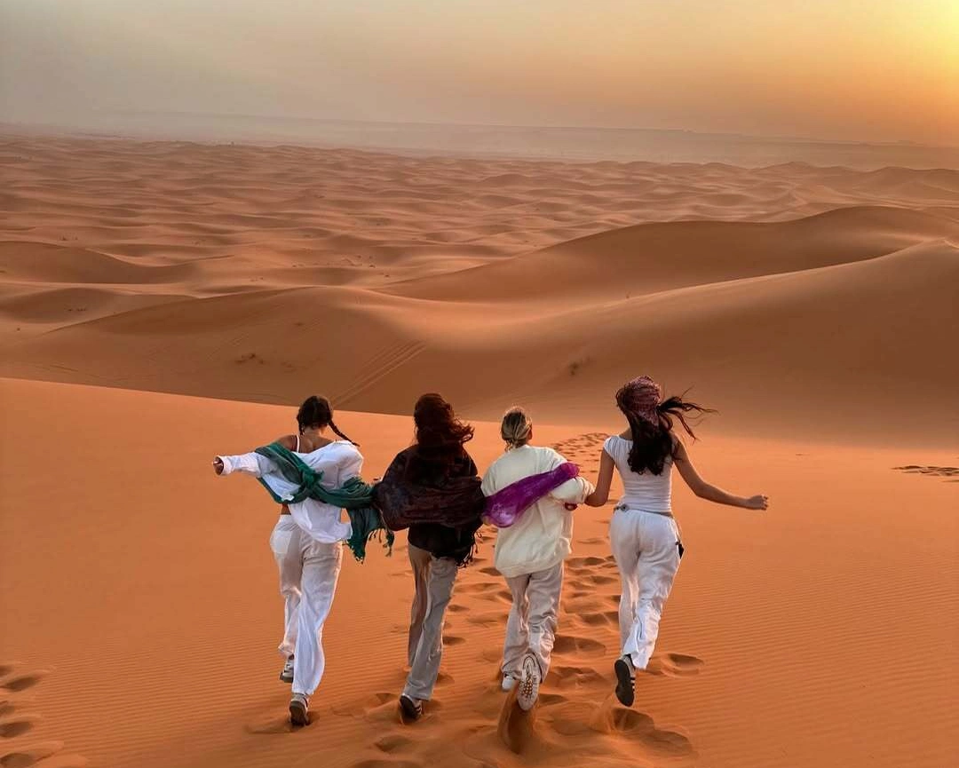 2 Days Tour from Marrakech to Merzouga 2 Tourists enjoying sunset in Merzouga during 2 days tour from Marrakech