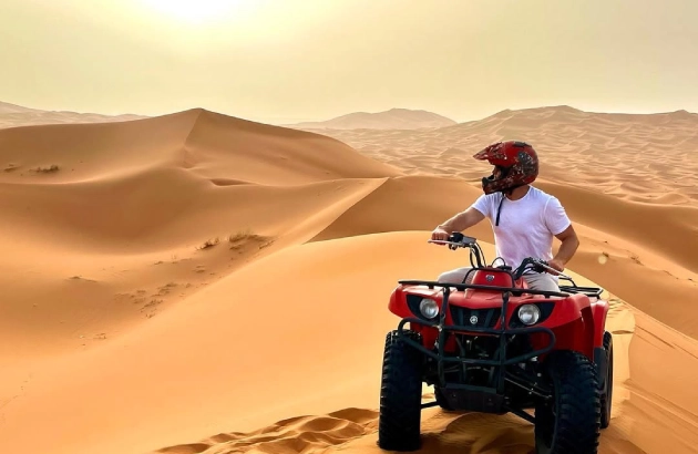 Quad bikes lined up on sand dune for sunrise in Merzouga tour