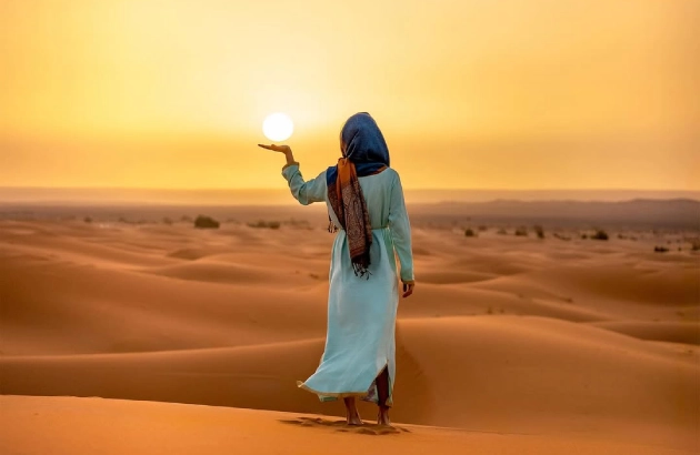 Stunning sunrise in Merzouga with golden light illuminating the Sahara sand dunes